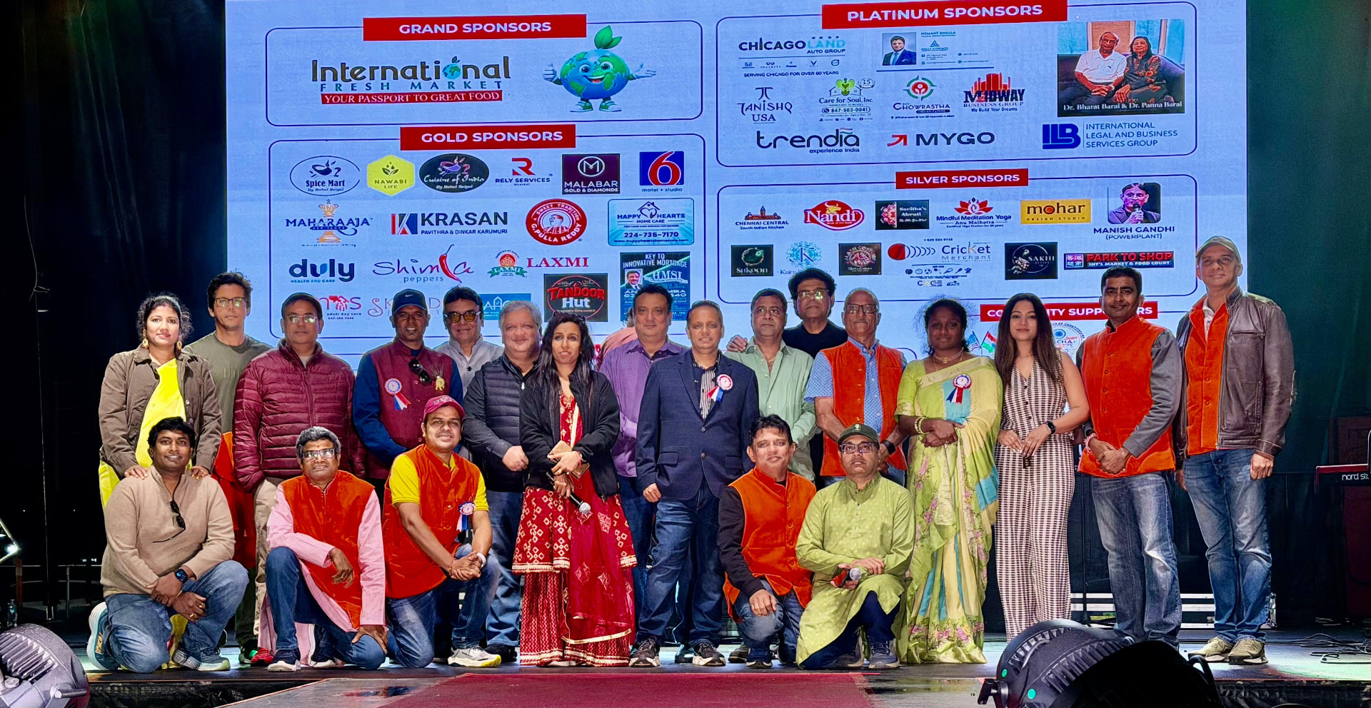 Swadeshi Mela 2026 team in front of the sponsor wall